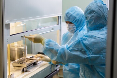 scientists working in a cleanroom injection molding